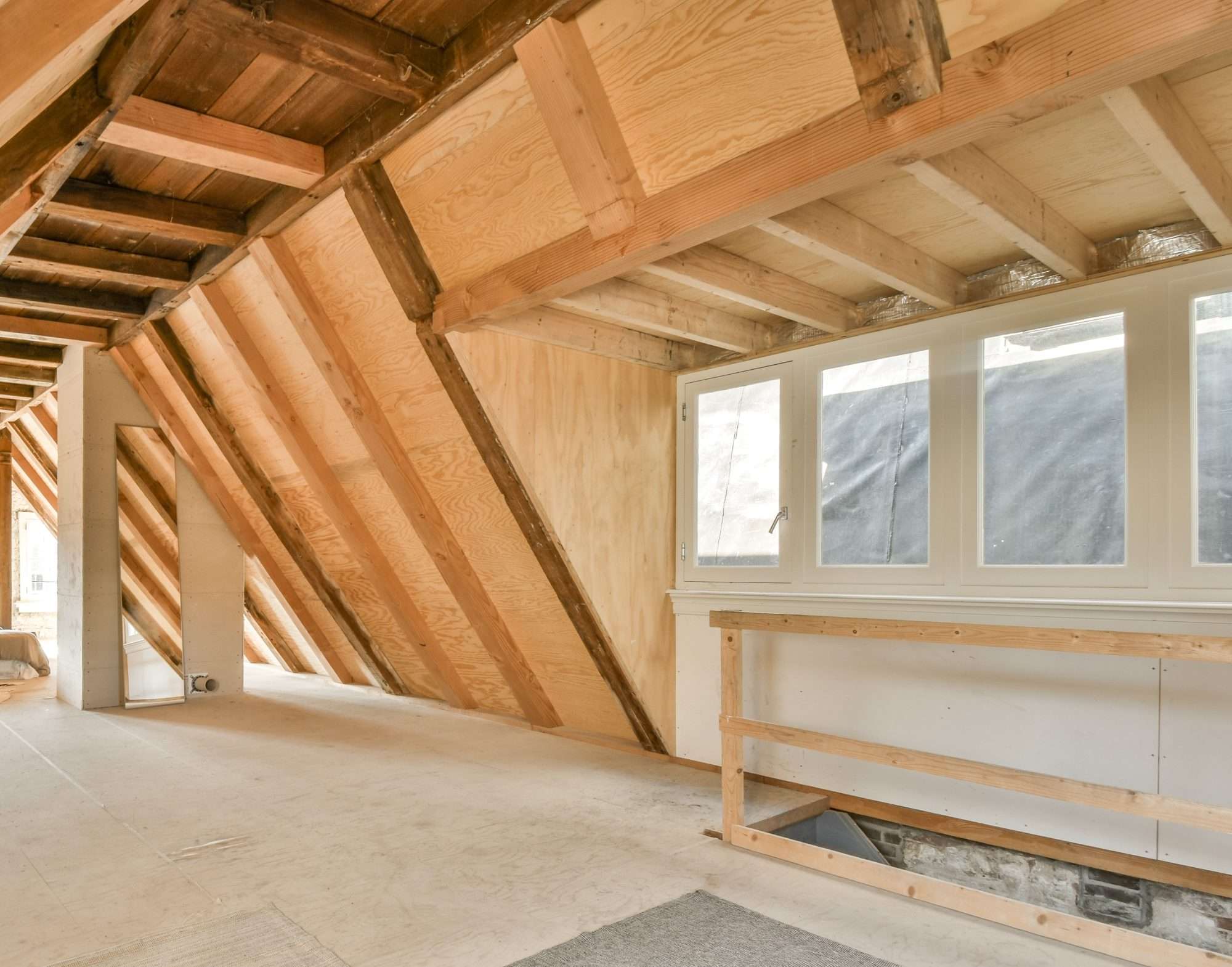 A cozy and spacious mansard styled empty room in a luxury house